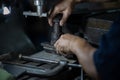 Close up hand heavy industrial worker is working on metal work factory process by performing mechanical turning operation at machi