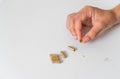 Close up hand with herb capsule on white background. Microdosing concept. Psychedelics therapy. Depression, anxiety