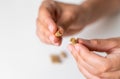 Close up hand with herb capsule on white background. Microdosing concept. Psychedelics therapy. Depression, anxiety