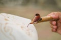 close up of hand hold canting is tool for make batik with isolated white background. Canting batik is tools to make batik. canting Royalty Free Stock Photo