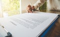 hand holding pen on check list paper And the format for filling in information in business concept Royalty Free Stock Photo