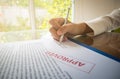 hand holding pen on check list paper And the format for filling in information in business concept Royalty Free Stock Photo