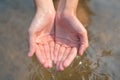 Close up hand hold Water liquid on river