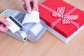 Close-up of hand holding a bank card above the cash register to pay for a purchase and issuing a check Royalty Free Stock Photo