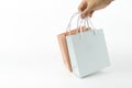 Close-up hand is holding blank or without logo paper shopping bag isolated on a white background Royalty Free Stock Photo