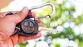 Close up hand holding car keys with foliage background Royalty Free Stock Photo