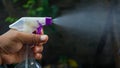 Close up of hand holding cleaning spray Royalty Free Stock Photo