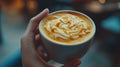 Close-up of a Hand Holding a Cup of Latte Art Royalty Free Stock Photo