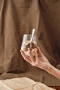 Close up of hand holding delicious layered dessert in glass jar, Homemade yogurt with granola and berries, Granola baked Royalty Free Stock Photo