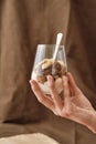 Close up of hand holding delicious layered dessert in glass jar, Homemade yogurt with granola and berries, Granola baked Royalty Free Stock Photo