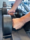 Close up of hand holding dumbbell in fitness. Exercise and healthy concept Royalty Free Stock Photo