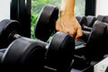 Close up of hand holding dumbbell in fitness or gym. Healthy, muscle, exercise and lifestyle. Royalty Free Stock Photo