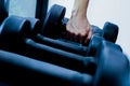 Close up of hand holding dumbbell in fitness or gym. Muscle, exercise and lifestyle. Royalty Free Stock Photo