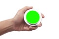 Close up of hand holding empty blank round silver metal object with green screen for copy space Royalty Free Stock Photo