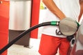Close up of a hand holding a fuel nozzle and filling up a car with gasoline Royalty Free Stock Photo