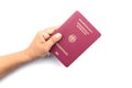 Close up hand holding German passport isolated on white Royalty Free Stock Photo