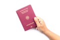 Close up hand holding German passport isolated on white Royalty Free Stock Photo