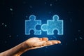 Close up of hand holding glowing digital blue jigsaw puzzle hologram on dark blurry background. Digital solution, collaboration, Royalty Free Stock Photo