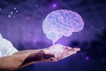 Close up of hand holding glowing human brain hologram on blurry purple background. Artificial intelligence, neurology, technology Royalty Free Stock Photo