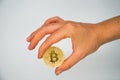 Close up hand holding a golden bitcoin / Isolated on white background / Digital currency / Money Trading in cryptocurrency Royalty Free Stock Photo