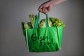 Close up a hand holding green grocery bag with Green Food text o Royalty Free Stock Photo