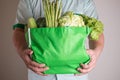 close up hand holding green grocery bag of mixed the organic green vegetables , healthy organic green food shopping and diet heal Royalty Free Stock Photo