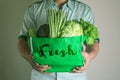 close up hand holding green grocery bag of mixed the organic green vegetables , healthy organic green food shopping and diet Royalty Free Stock Photo