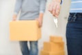 Close up of hand holding a key while a man holding a box to move Royalty Free Stock Photo