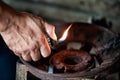 Close up hand holding lighter over old gas Royalty Free Stock Photo