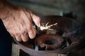 Close up hand holding lighter over old gas Royalty Free Stock Photo