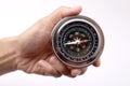 Close up of hand holding magnetic silver metal compass Royalty Free Stock Photo