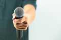 Close up hand holding microphone for speaker speech presentation stage performance and Royalty Free Stock Photo
