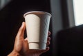 Close-up of a hand holding a paper cup with coffee, mockup illustration for design, Royalty Free Stock Photo