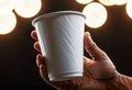 Close-up of a hand holding a paper cup with coffee, mockup illustration for design, Royalty Free Stock Photo