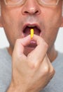 Close up of hand holding a pill