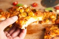 close-up of hand holding pizza slice of Traditional Italian pizza. Traditional food from Palermo, Sicily, Italy. Ingredients Royalty Free Stock Photo