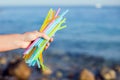 Close Up Of Hand Holding Plastic Straws Polluting Beach. Environmental pollution concept Royalty Free Stock Photo