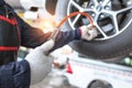 Close-Up Of Hand holding pressure gauge for car tyre pressure measurement in auto Car repair shop Royalty Free Stock Photo