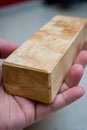 Close-up of hand holding rectangular wooden block Royalty Free Stock Photo