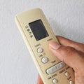 Close up of hand holding remote control against white background Royalty Free Stock Photo