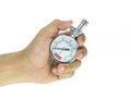 Close up hand holding silver tyre pressure gauge isolated on whi Royalty Free Stock Photo