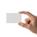 Human hand holding a blank rectangular card between thumb and forefinger isolated on white background Royalty Free Stock Photo