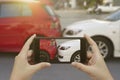 Close up hand holding smartphone and take photo at The scene of a car crash and accident, car accident for car insuranc claim Royalty Free Stock Photo