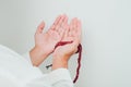 Close up Hand holding a tasbih or prayer beads