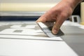 Close-up of a man`s hand holding a trowel and preparing to make car stickers on vinyl