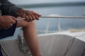 Close up of a hand pulling a rope, sheet on a sailboat