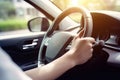 Close up hand holing or controlling steering wheel of car for driving, point of view inside car, on the highway road, with Royalty Free Stock Photo