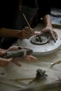 Close-up hand image of a man using a sculpting tool on raw clay to create shapes Royalty Free Stock Photo