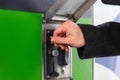 Close up of hand inserting coin into slot machine at car wash. Self service Royalty Free Stock Photo
