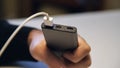 Close up of hand inserting a USB cable charger into portable power bank. Media. Close up of mans hand inserting a cable Royalty Free Stock Photo